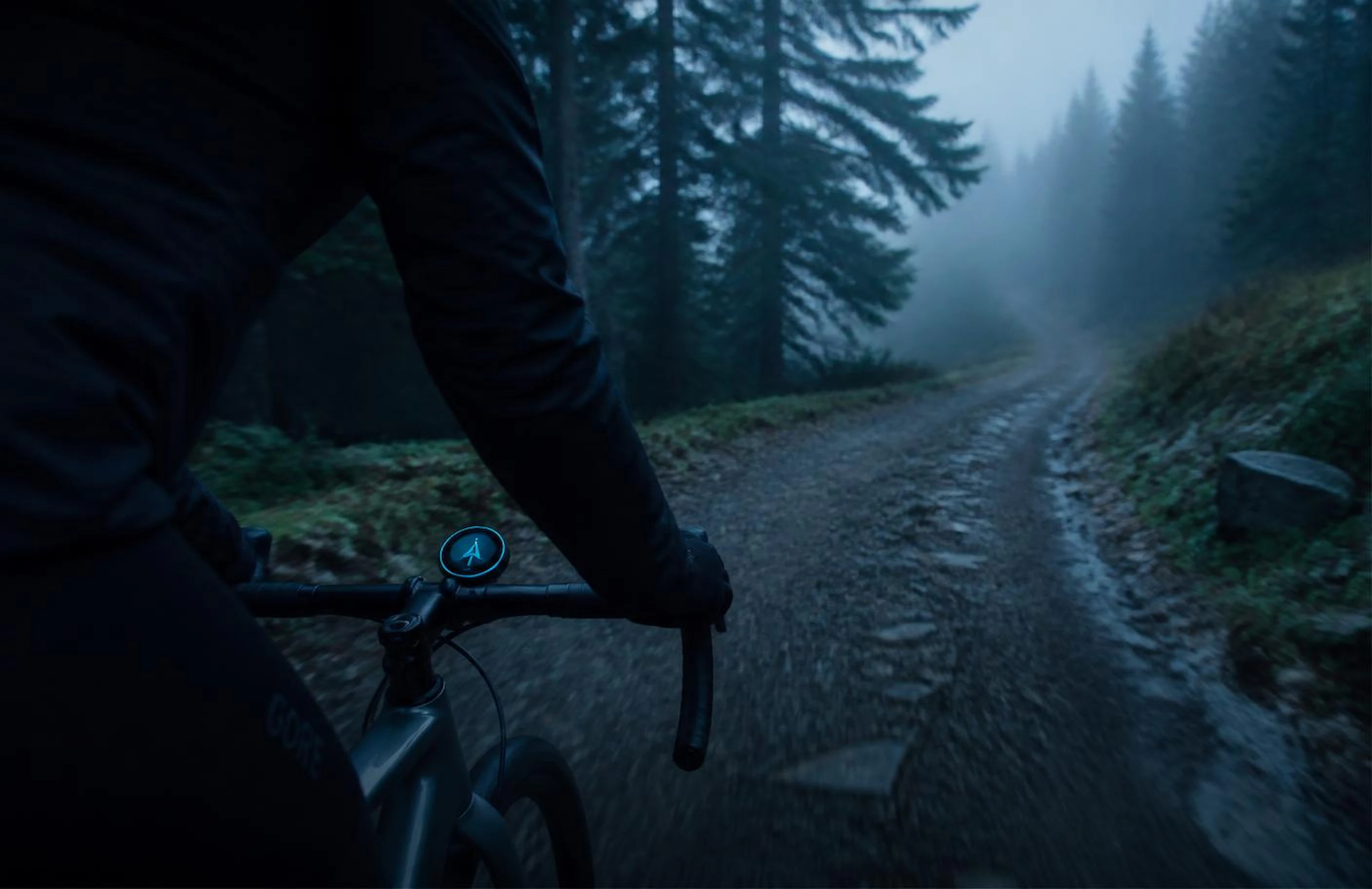 Gravel cyclist on a misty forest trail with a RYDARO navigator on the bars